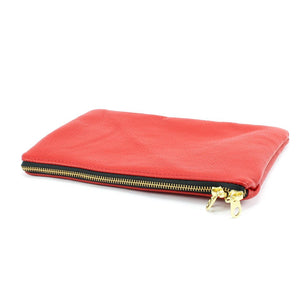 a red purse with a gold zipper on a white background